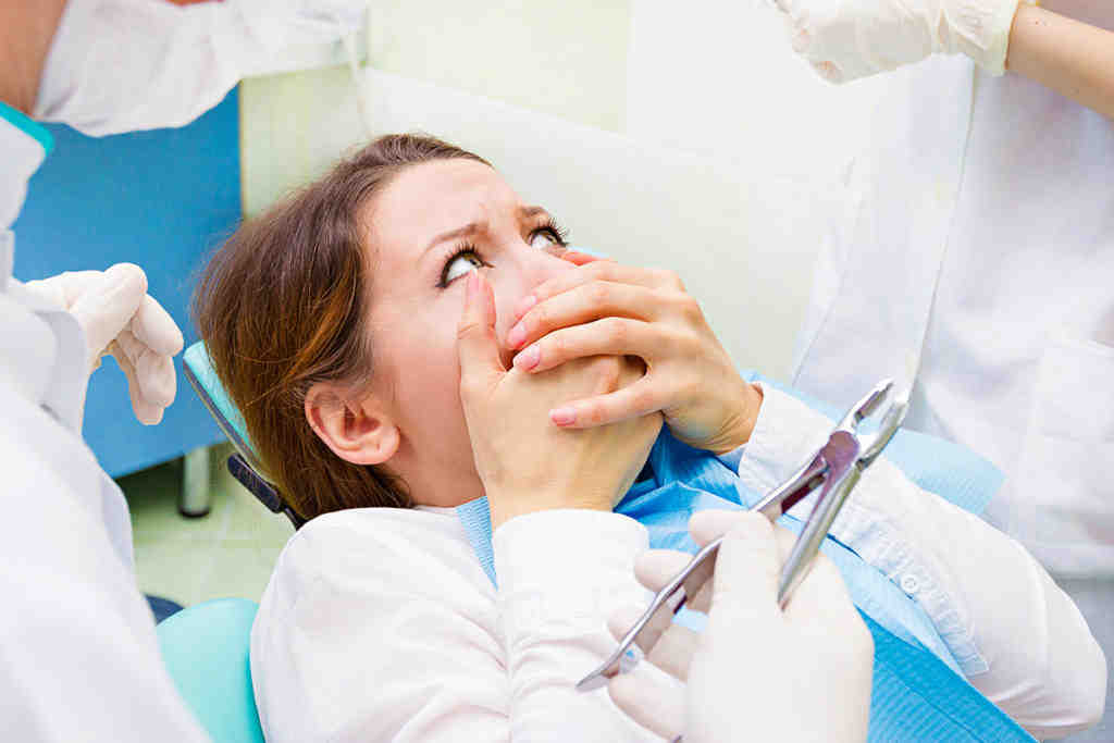 How does a biological dentist treat a root canal?