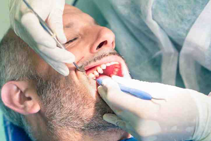 Should I go to the dentist for wisdom tooth pain?